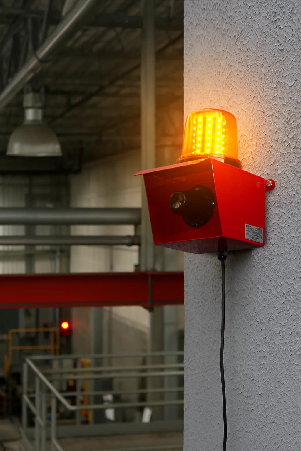 Sinalizador audiovisual BTK-SRZGDR1 instalado em galpão industrial com estrutura metálica